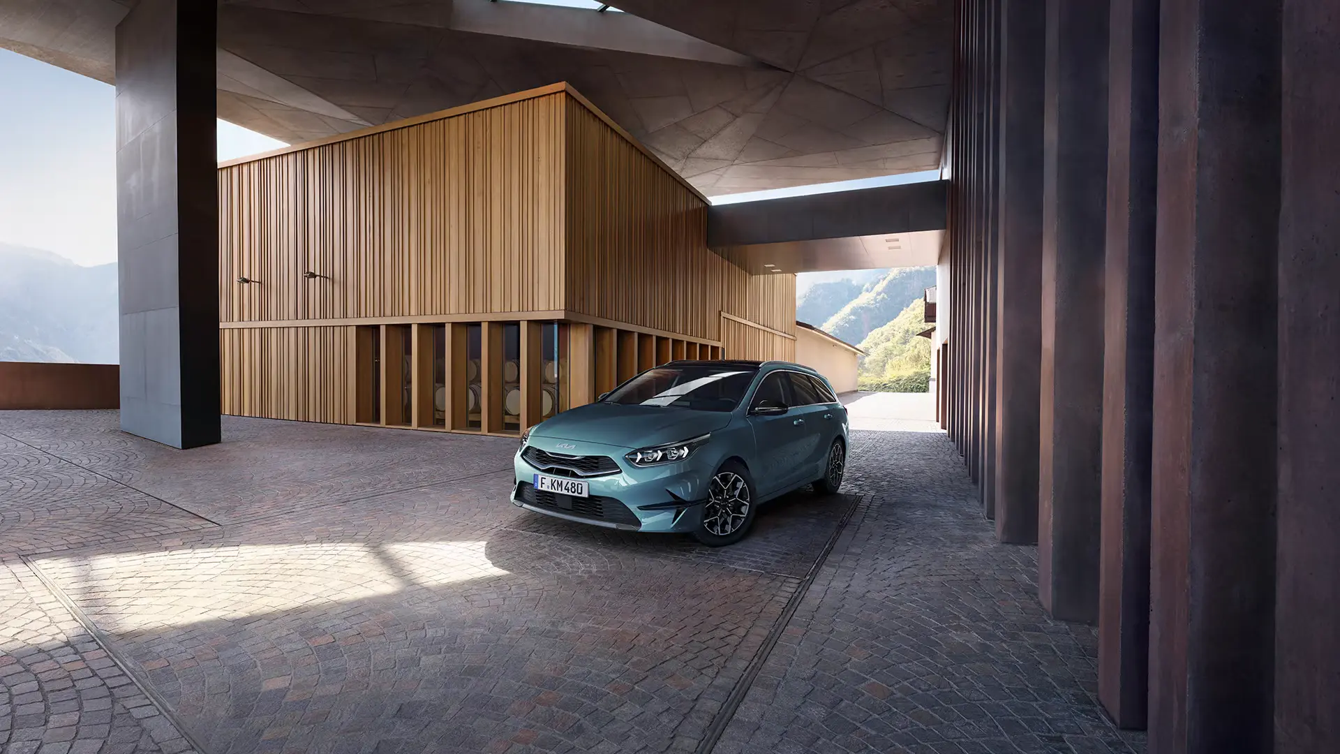 Ein blauer Kia Ceed SW steht vor einem modernen Gebäude.